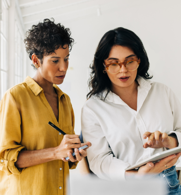 Two women looking at an iPad.